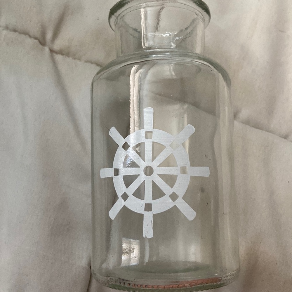 Glass bottle with ship wheel used for decoration